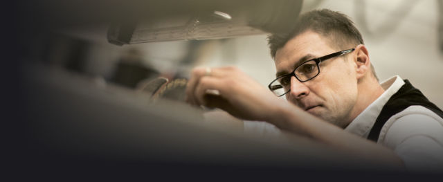 A photo of a woodworker using an Altendorf sliding table saw