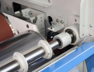 A close-up photo of an Osama glueing roller system