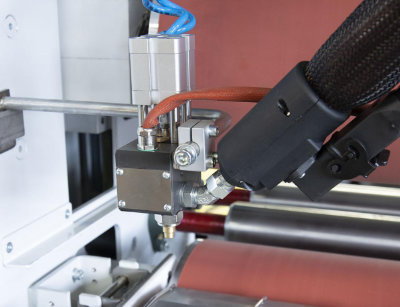 A close-up photo of an Osama glueing roller system