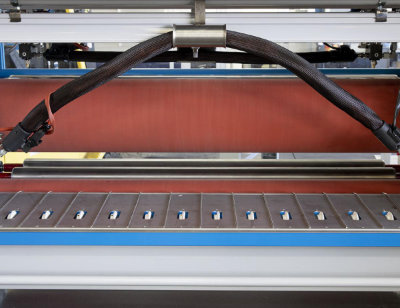 A close-up photo of an Osama glueing roller system