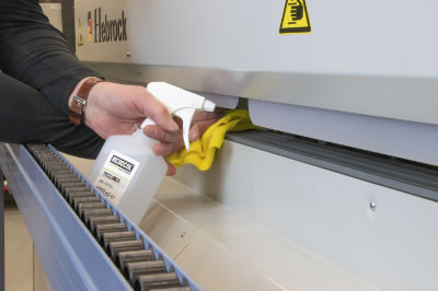 An image of an edgebander being cleaned by an engineer